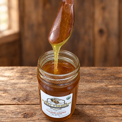 Raw Organic Yucatán honey 1 lb jar with honey spoon on a rustic wood table