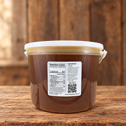 Raw Organic Yucatán honey 5 lb bucket back label on a rustic wood table